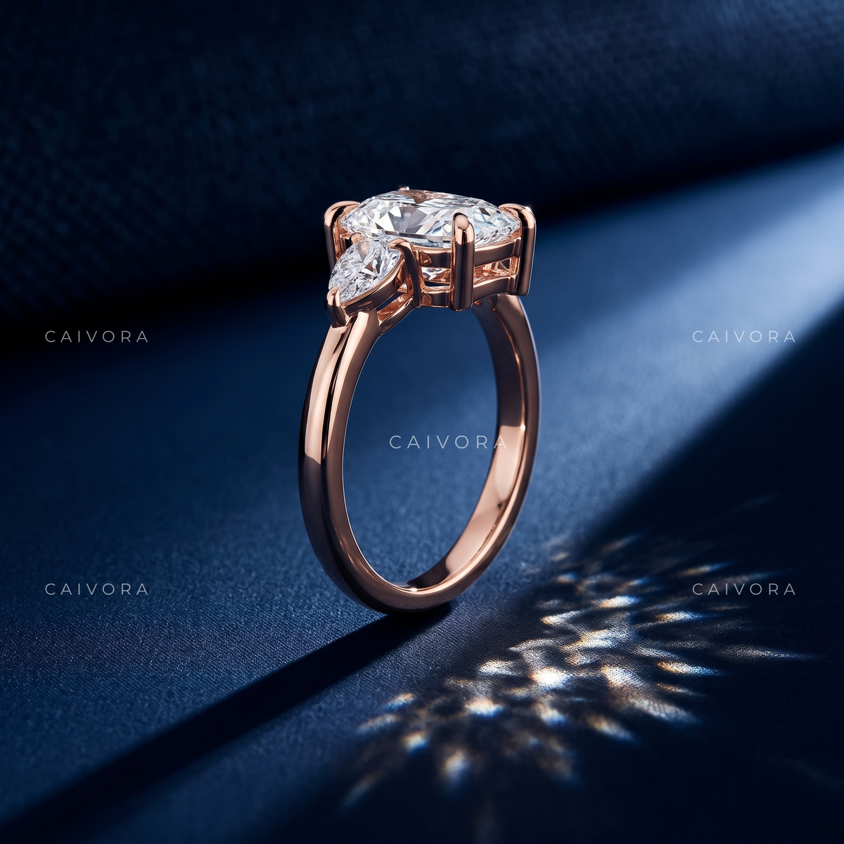 Romantic Three Stone Design Framed by a Cushion Cut Center