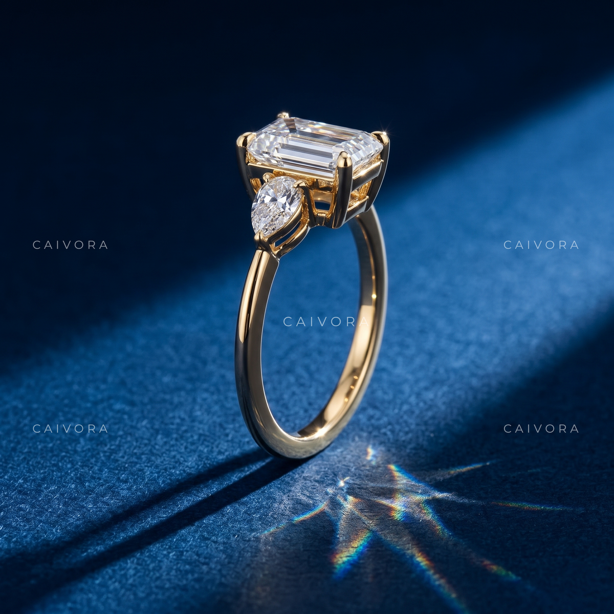 Modern Three Stone Engagement Ring Showcasing an Emerald Cut Center Diamond