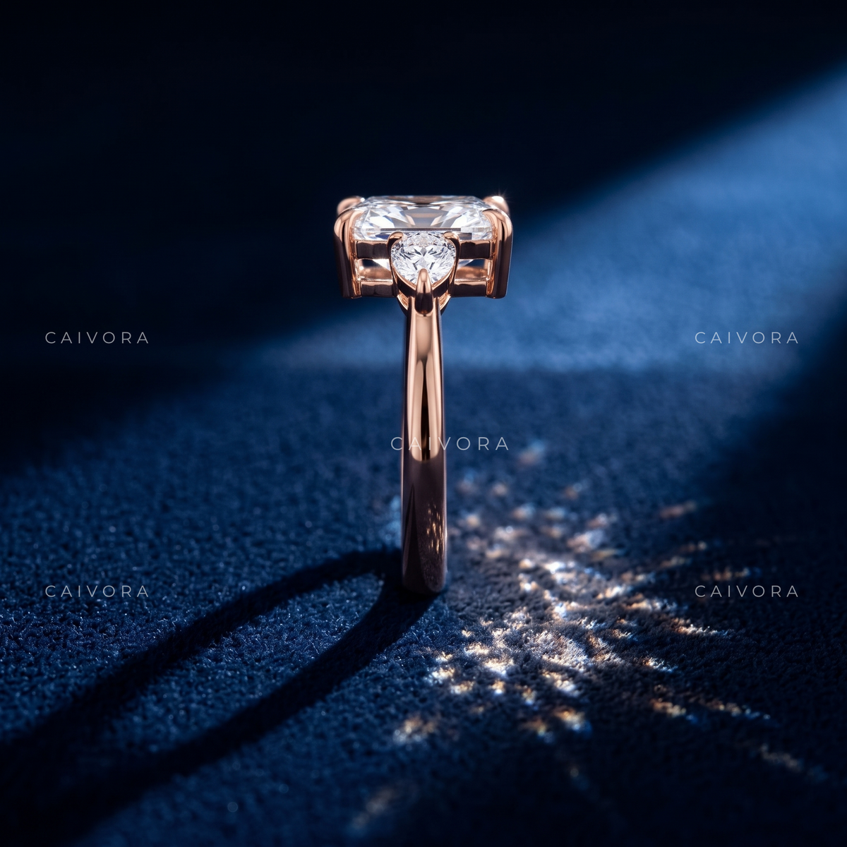 Romantic Three Stone Design Framed by a Cushion Cut Center