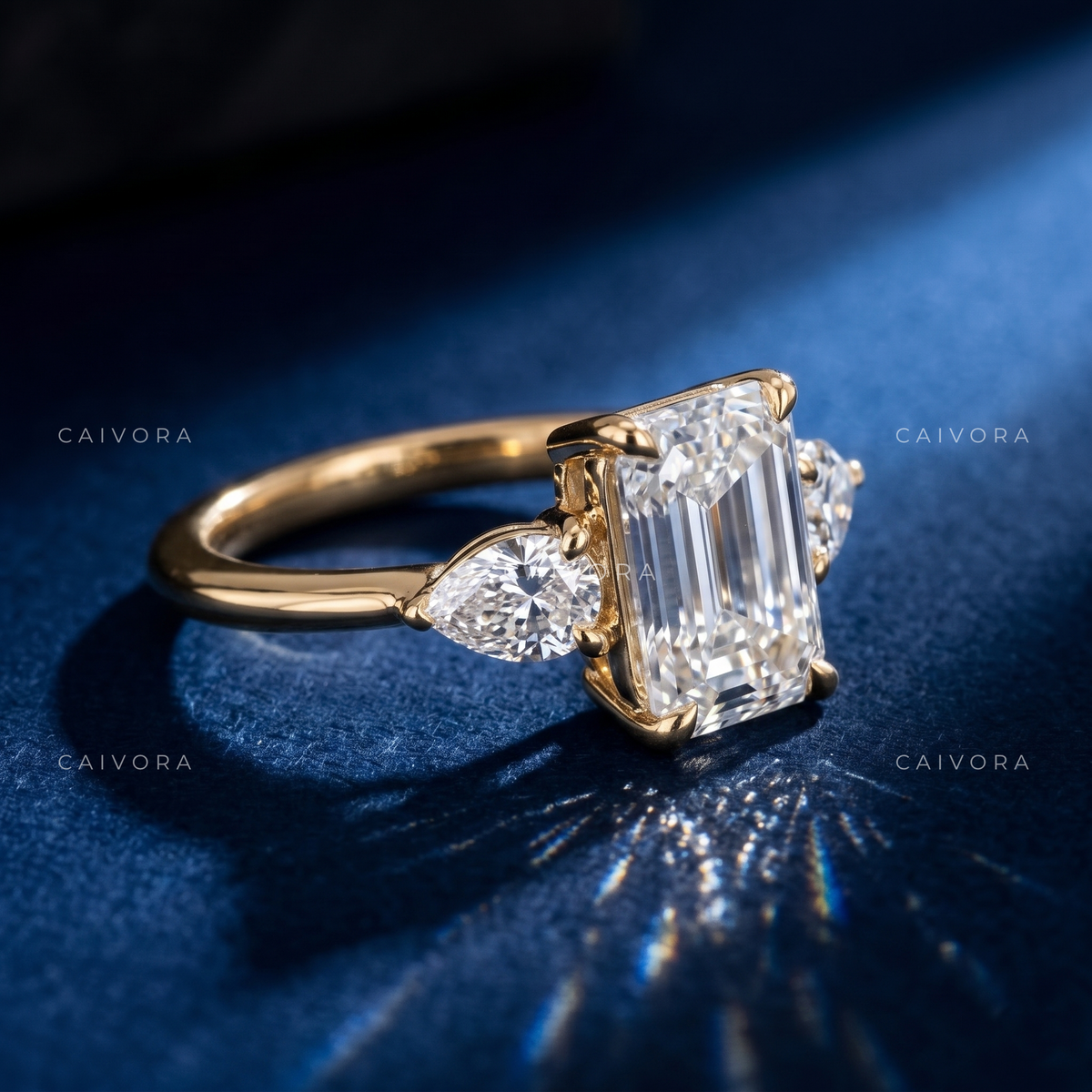 Modern Three Stone Engagement Ring Showcasing an Emerald Cut Center Diamond