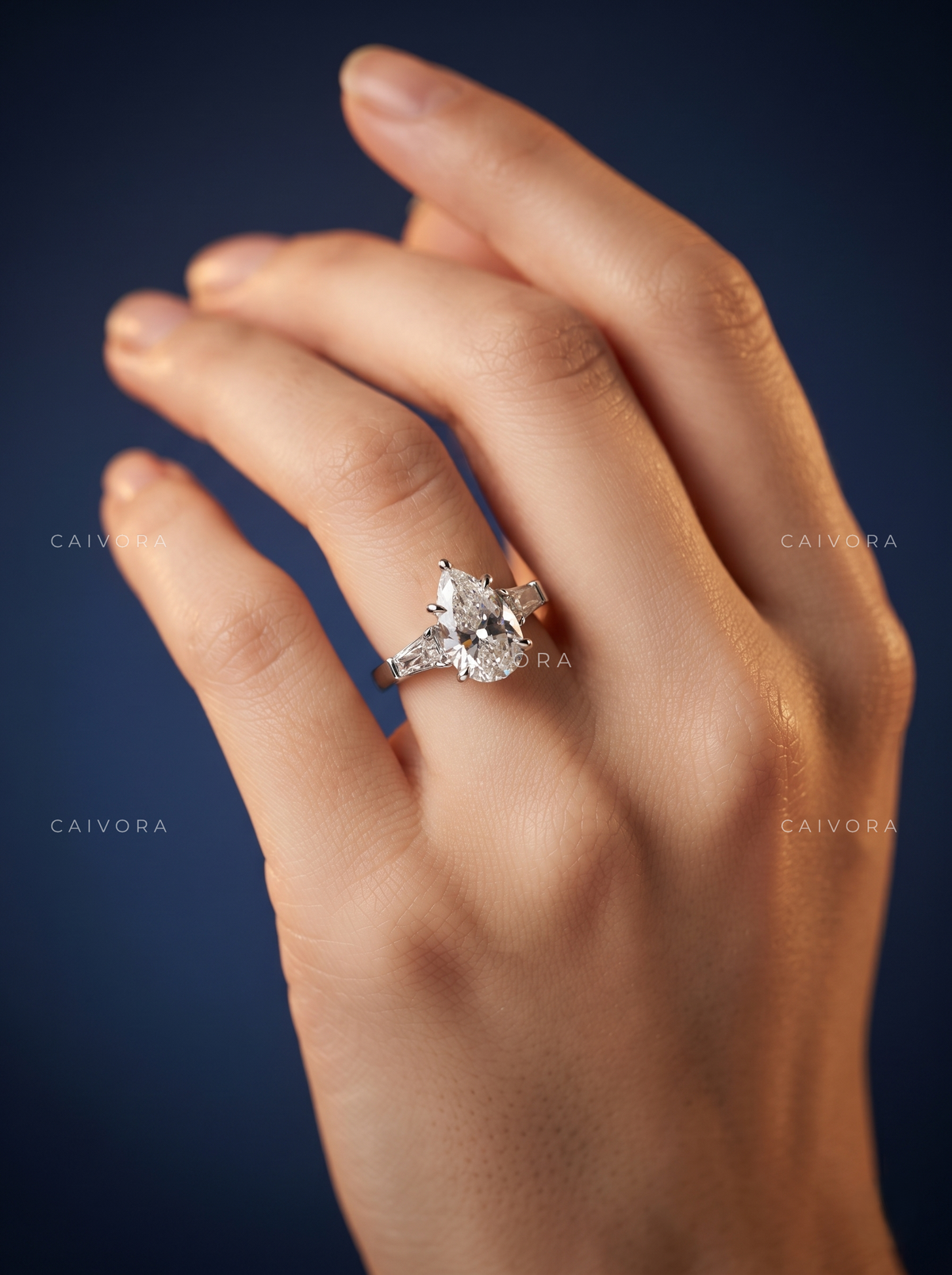 Graceful Contours with a Pear Cut Center Diamond