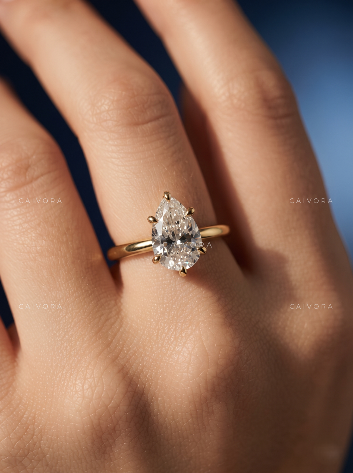 Refined Tapered Cathedral Setting with a Pear Cut Center Diamond