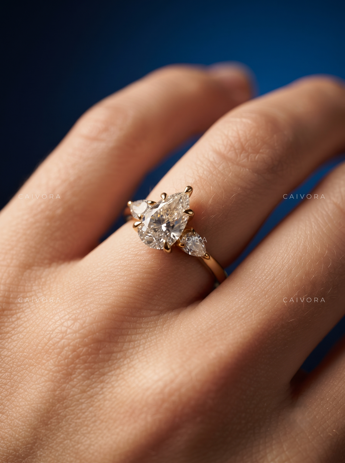 Elegant Three Stone Diamond Setting with a Pear Cut Center