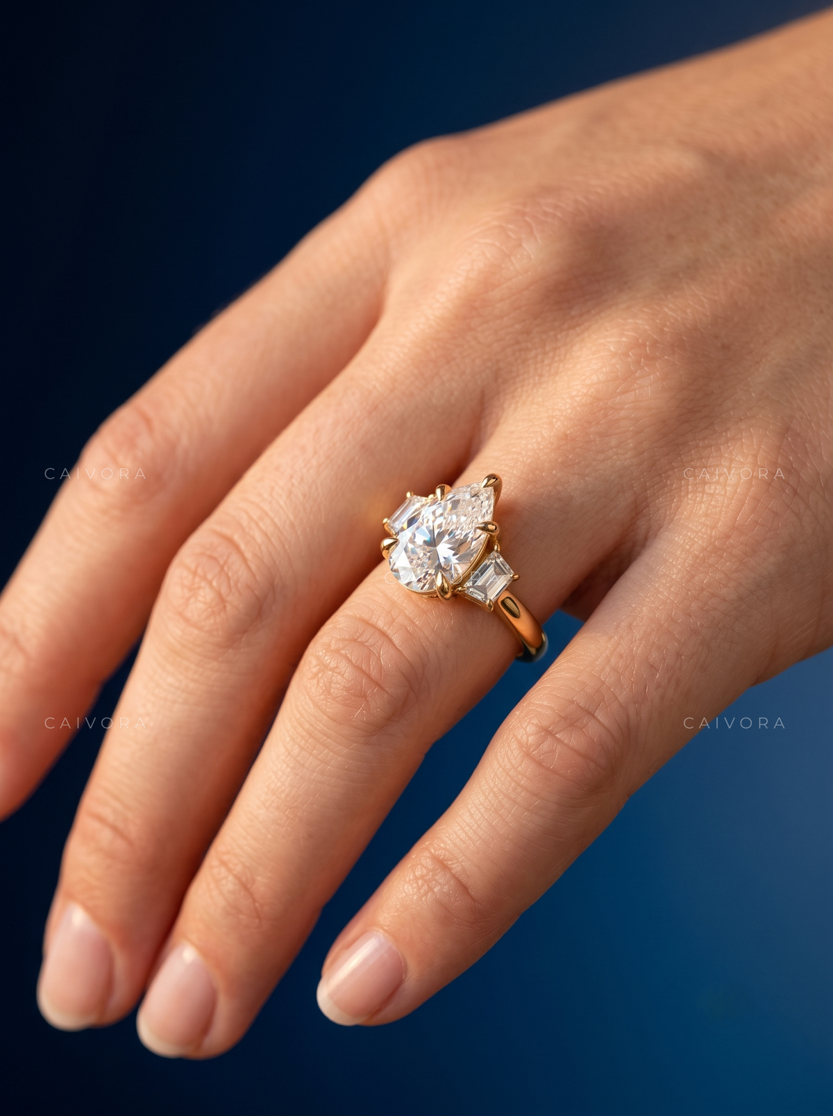 Elegant Three Stone Engagement Ring with Pear Diamond & Trapezoid Accents