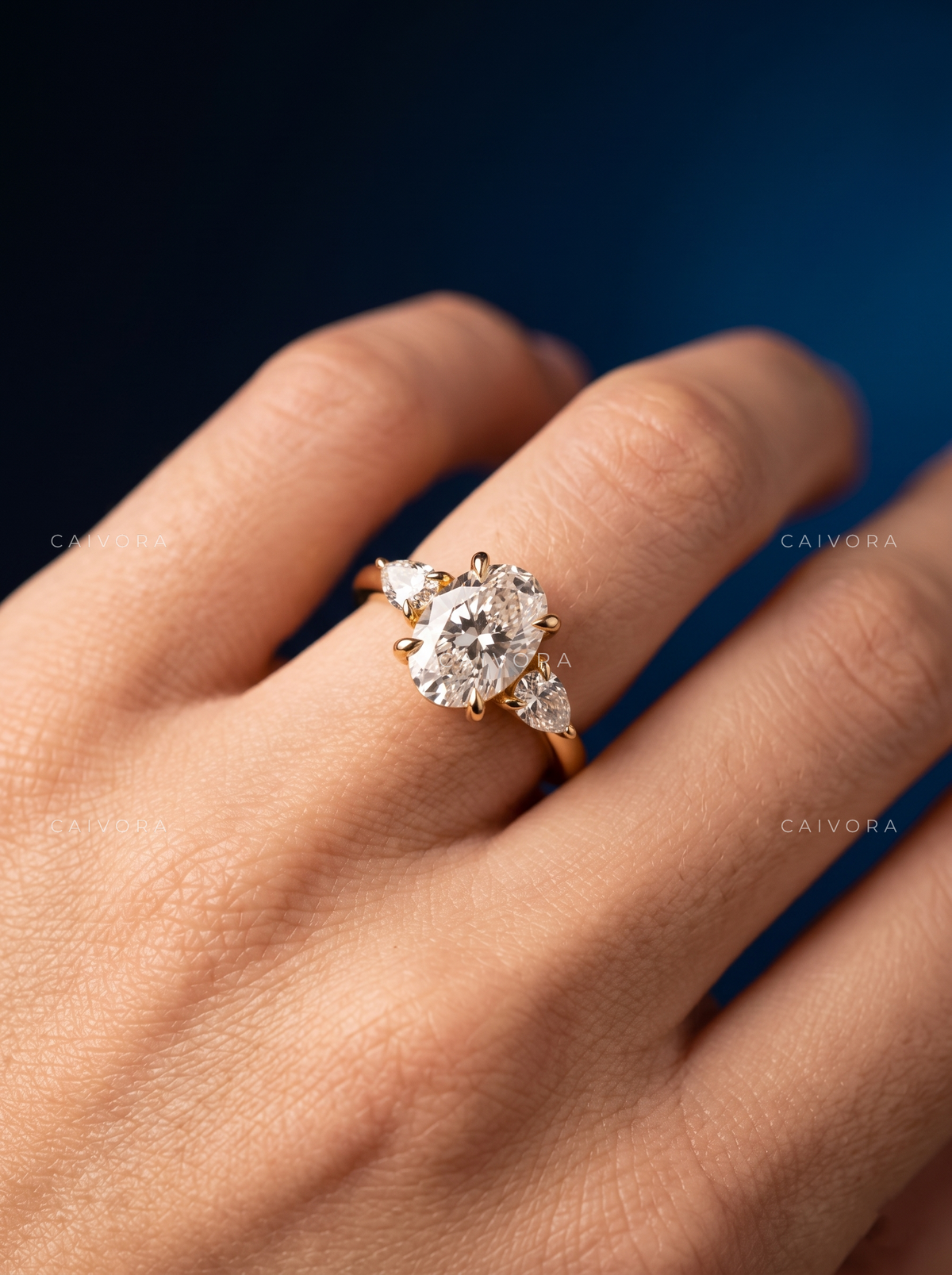 Sophisticated Three Stone Setting Highlighting an Oval Cut Center Diamond