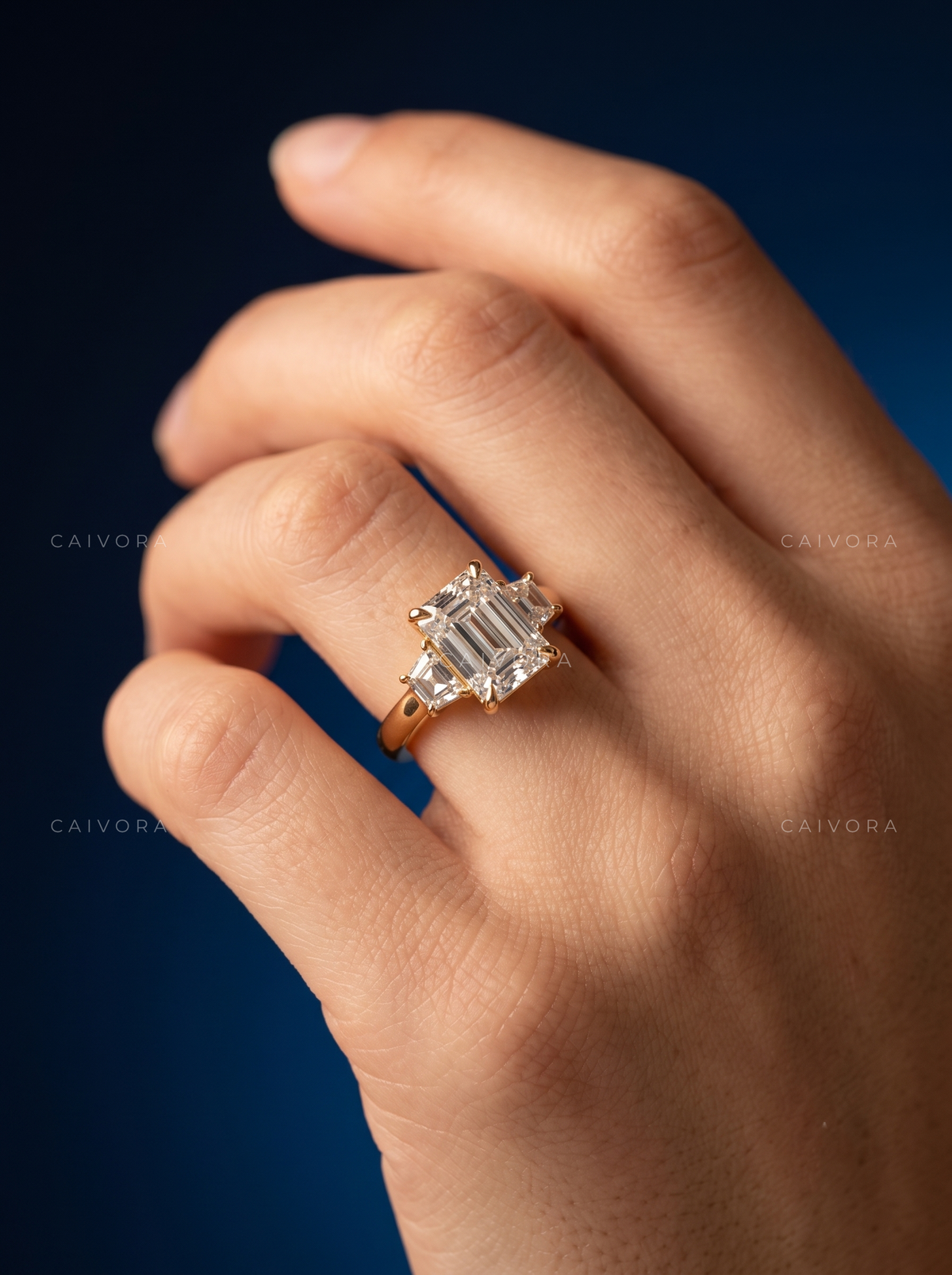 Modern Three Stone Engagement Ring with Emerald Diamond & Trapezoid Accents