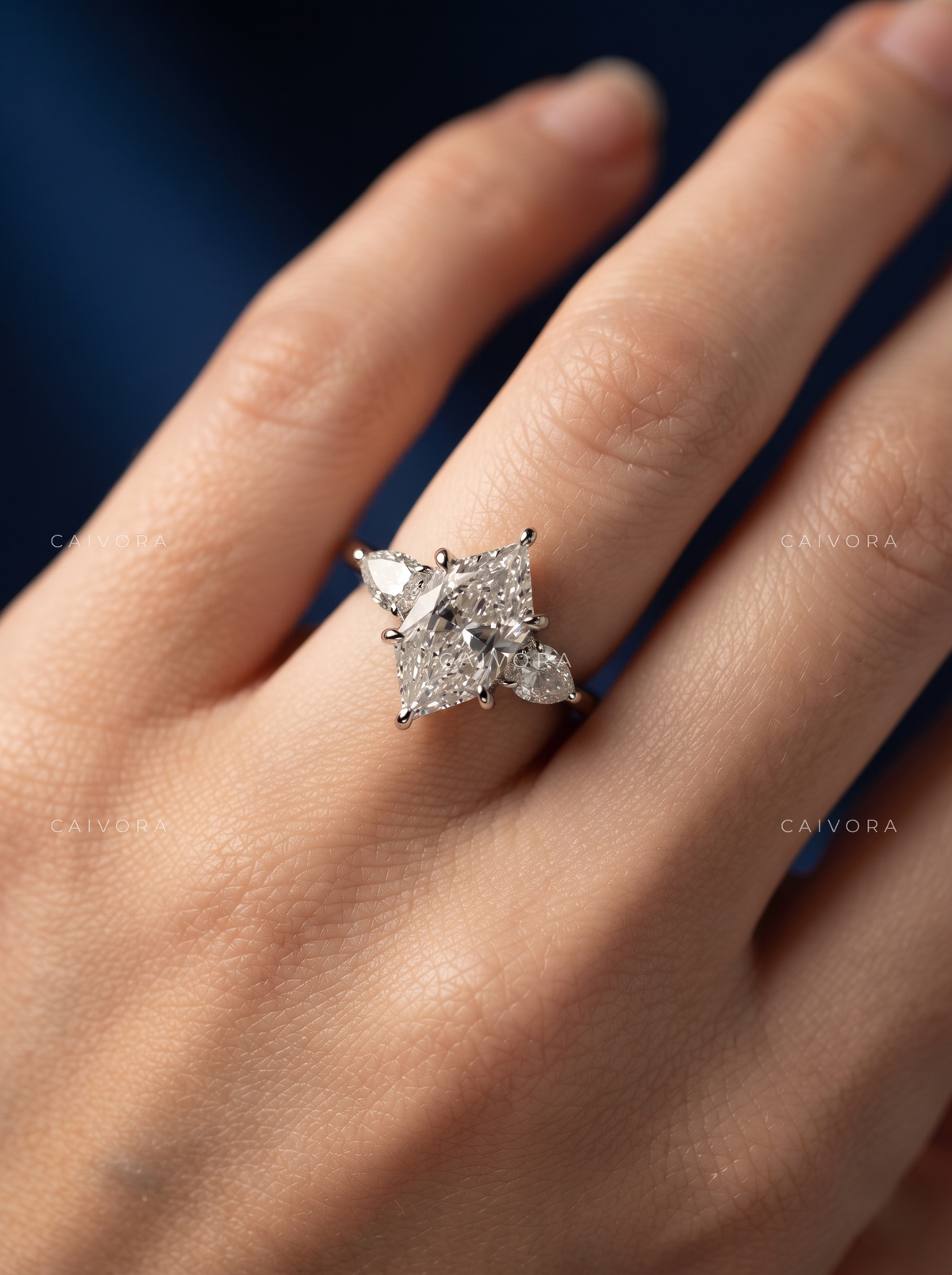 A Distinctive Three Stone Setting Featuring a Hexagon Cut Center