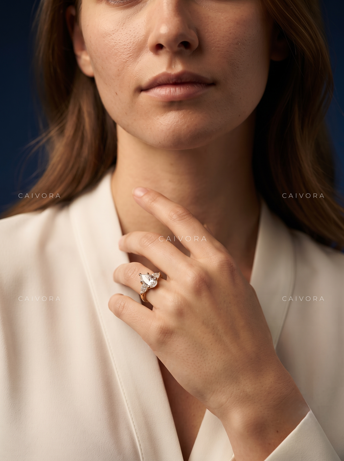 Elegant Three Stone Diamond Setting with a Pear Cut Center