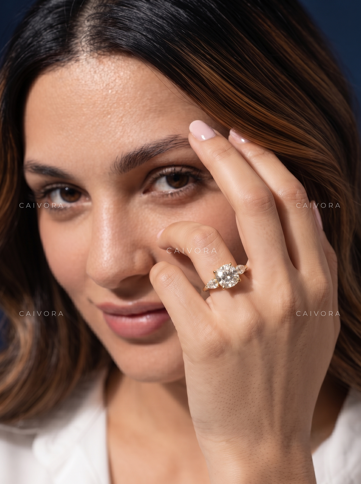 Graceful Three Stone Diamond Ring Featuring a Cushion Cut Center
