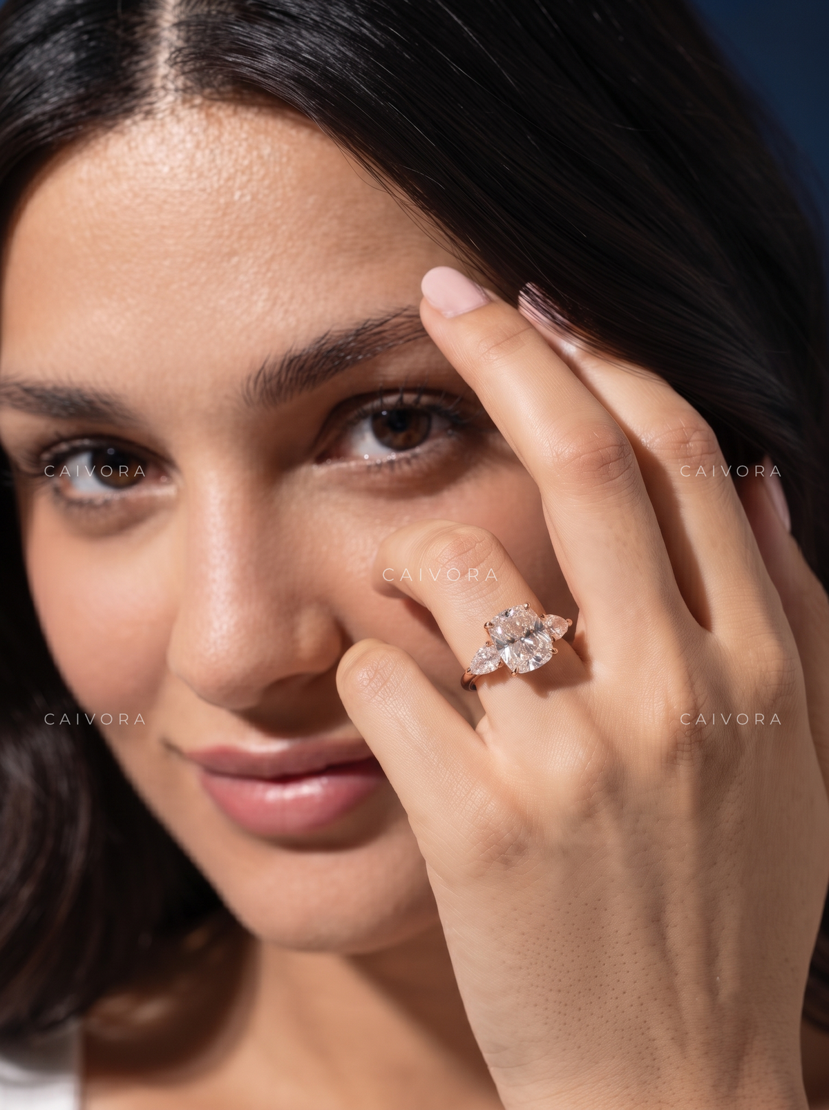 Romantic Three Stone Design Framed by a Cushion Cut Center