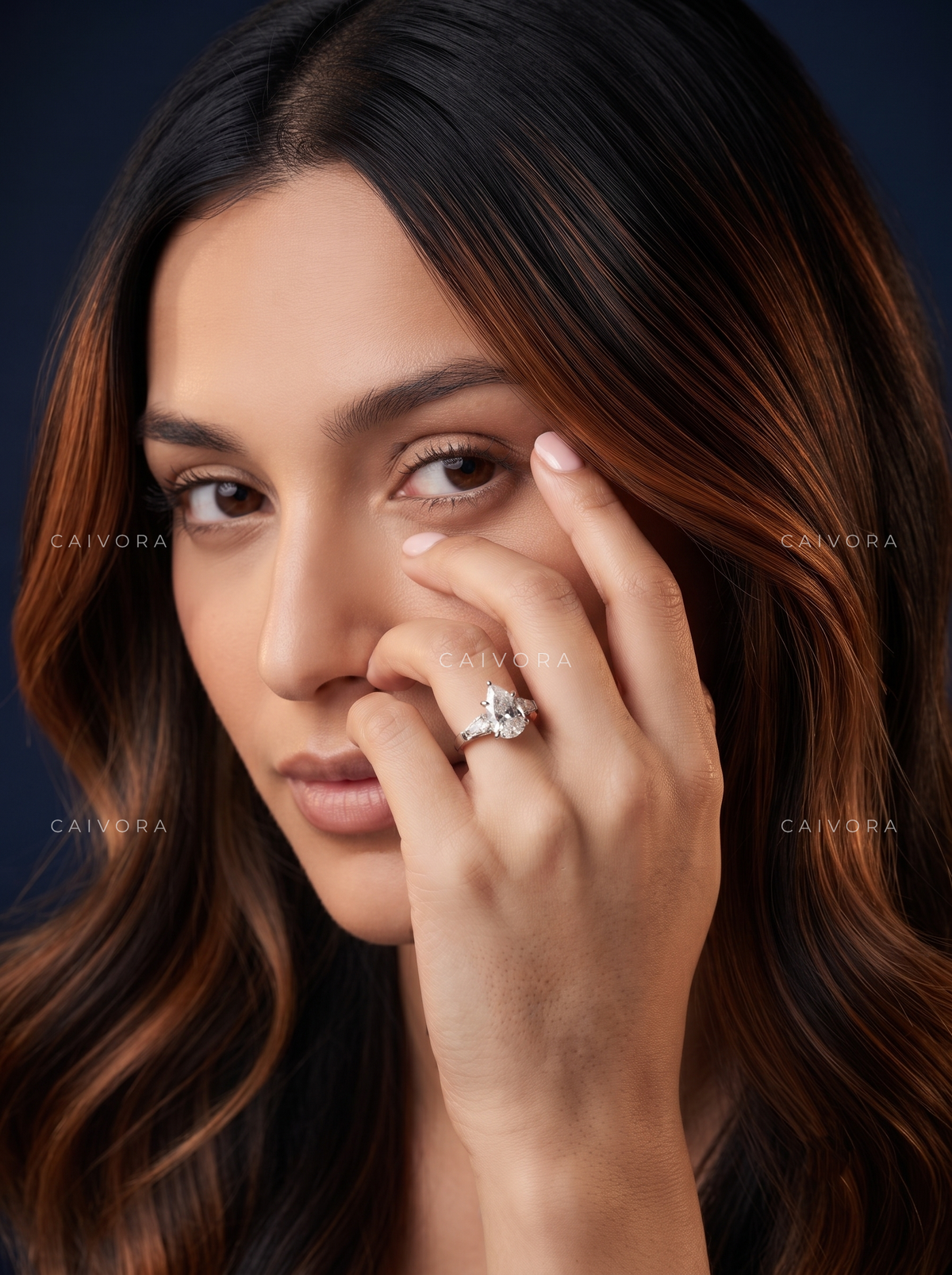 Graceful Contours with a Pear Cut Center Diamond