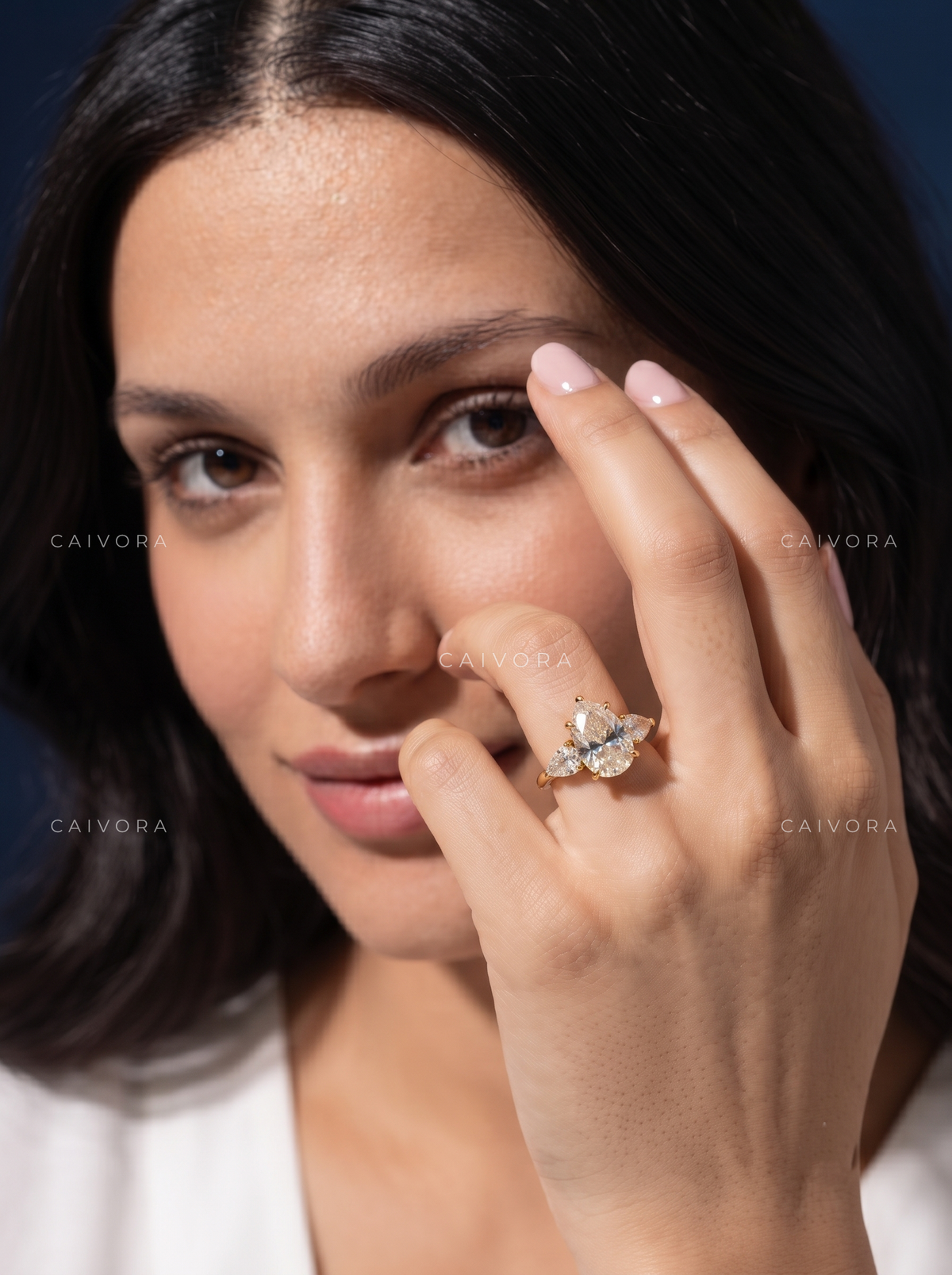 Elegant Three Stone Diamond Setting with a Pear Cut Center
