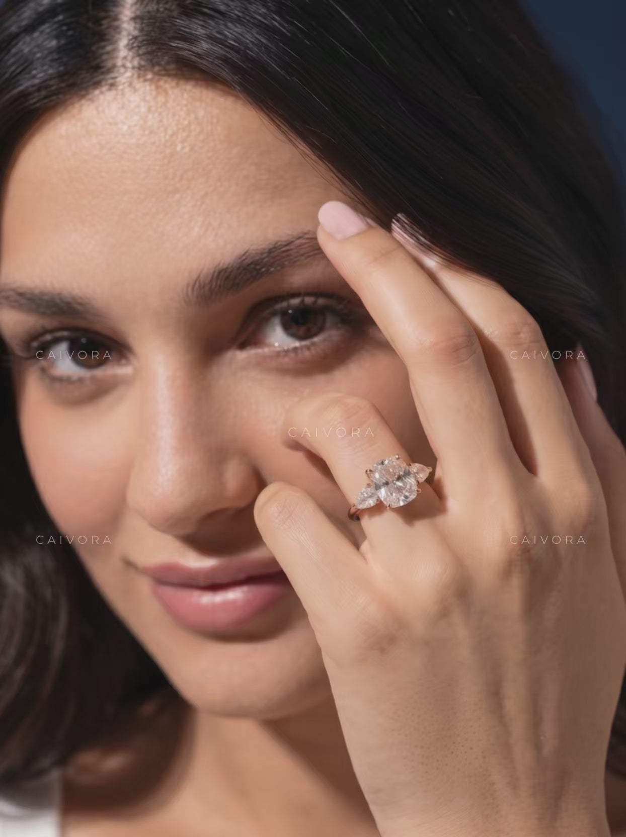 Romantic Three Stone Design Framed by a Cushion Cut Center