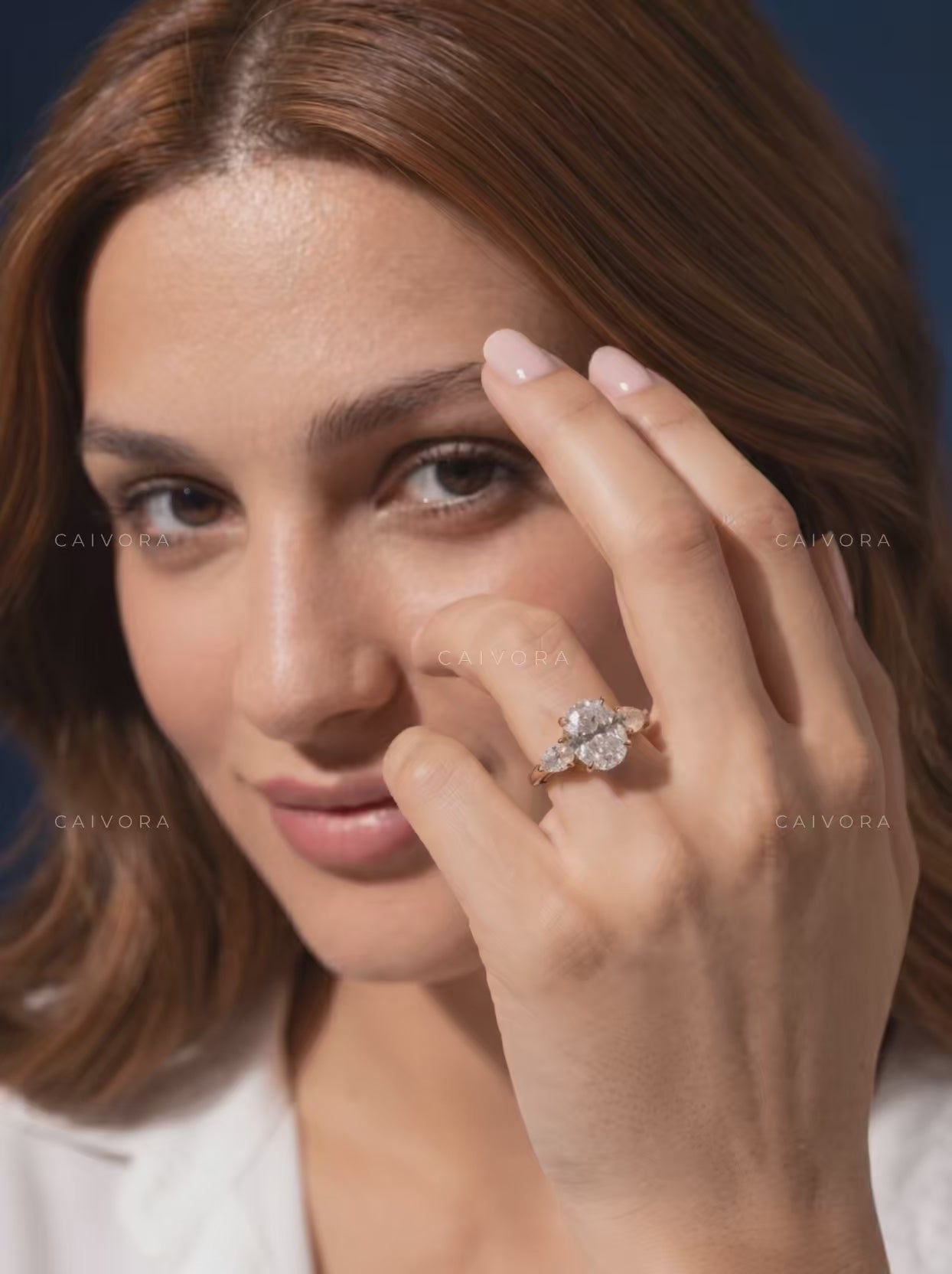 Sophisticated Three Stone Setting Highlighting an Oval Cut Center Diamond