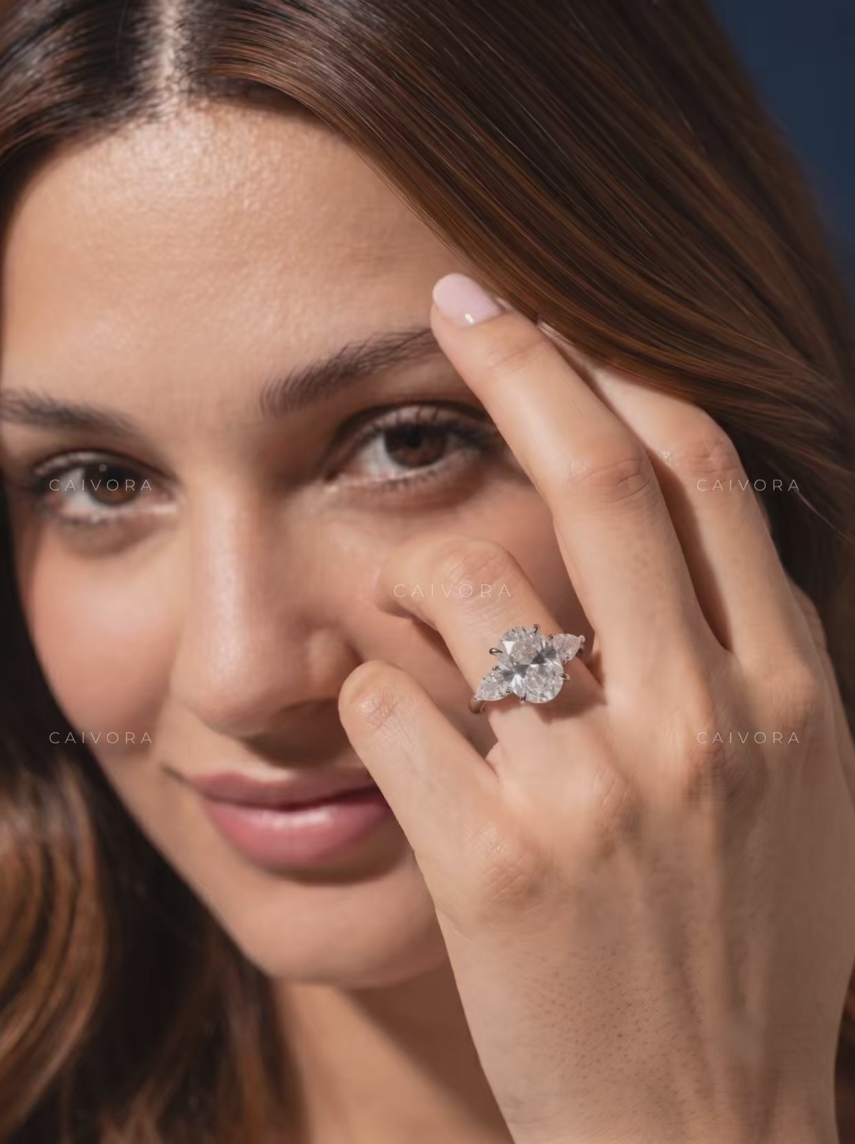 Graceful Three Stone Silhouette with an Moval Cut Center